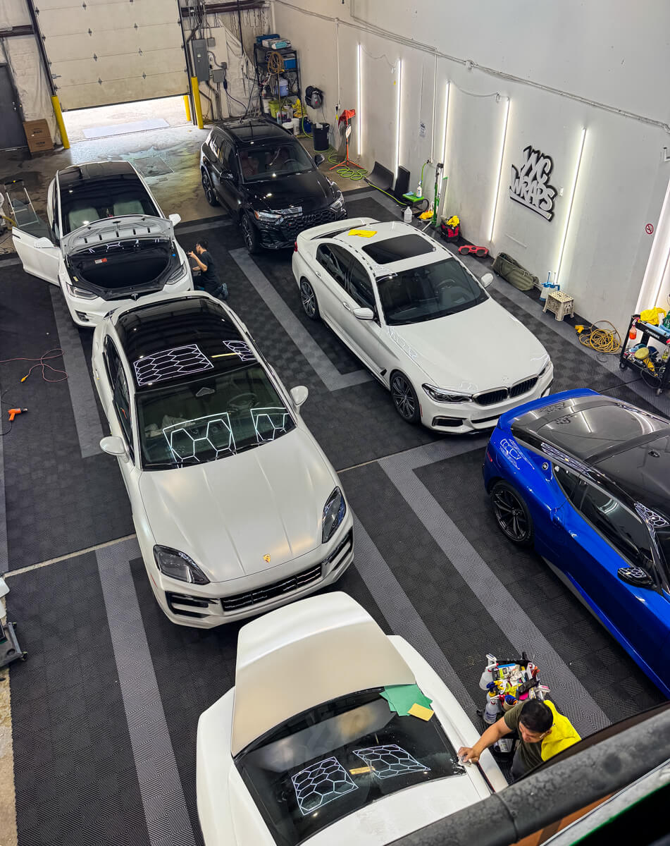 The YYC Wraps shop floor in Calgary — vehicles in for wrap, tint, PPF and ceramic